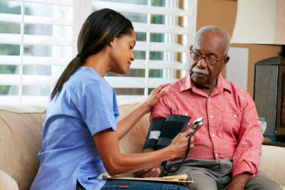 nurse getting blood pressure of senior man